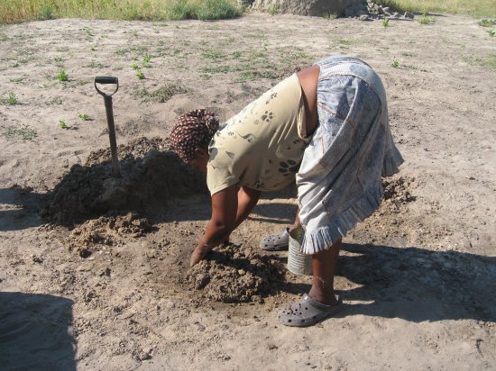 Esther making mud for her home