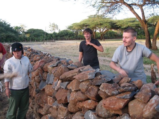 hurling wood and rocks over wall