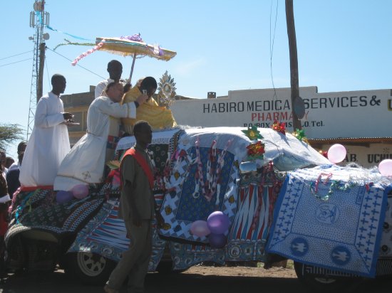 Isiolo priest taking pics with his cell phone