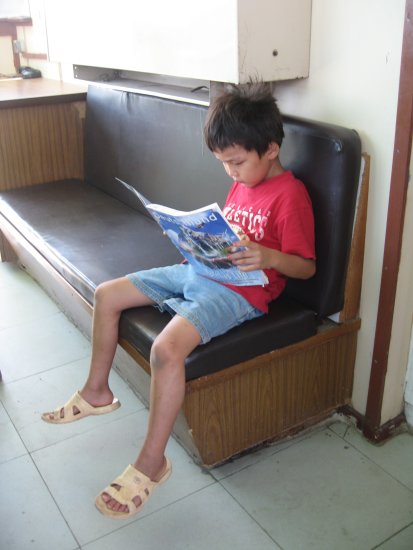 the other brother engrossed in a magazine