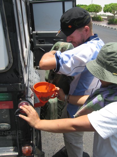 emptying jerry cans full of diesel