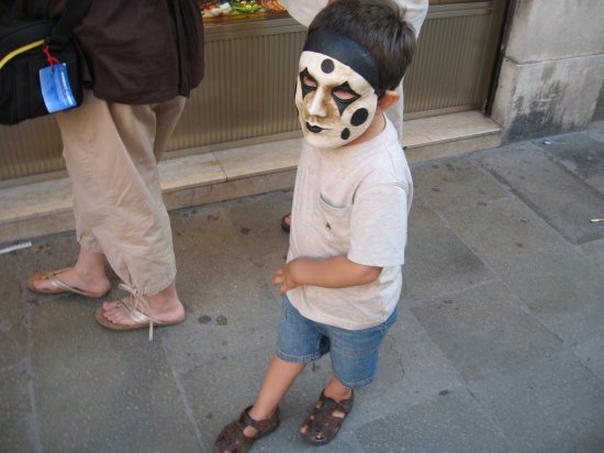 little boy wearing famous Venitian mask