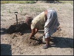 Esther making mud for her home