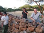 hurling wood and rocks over wall